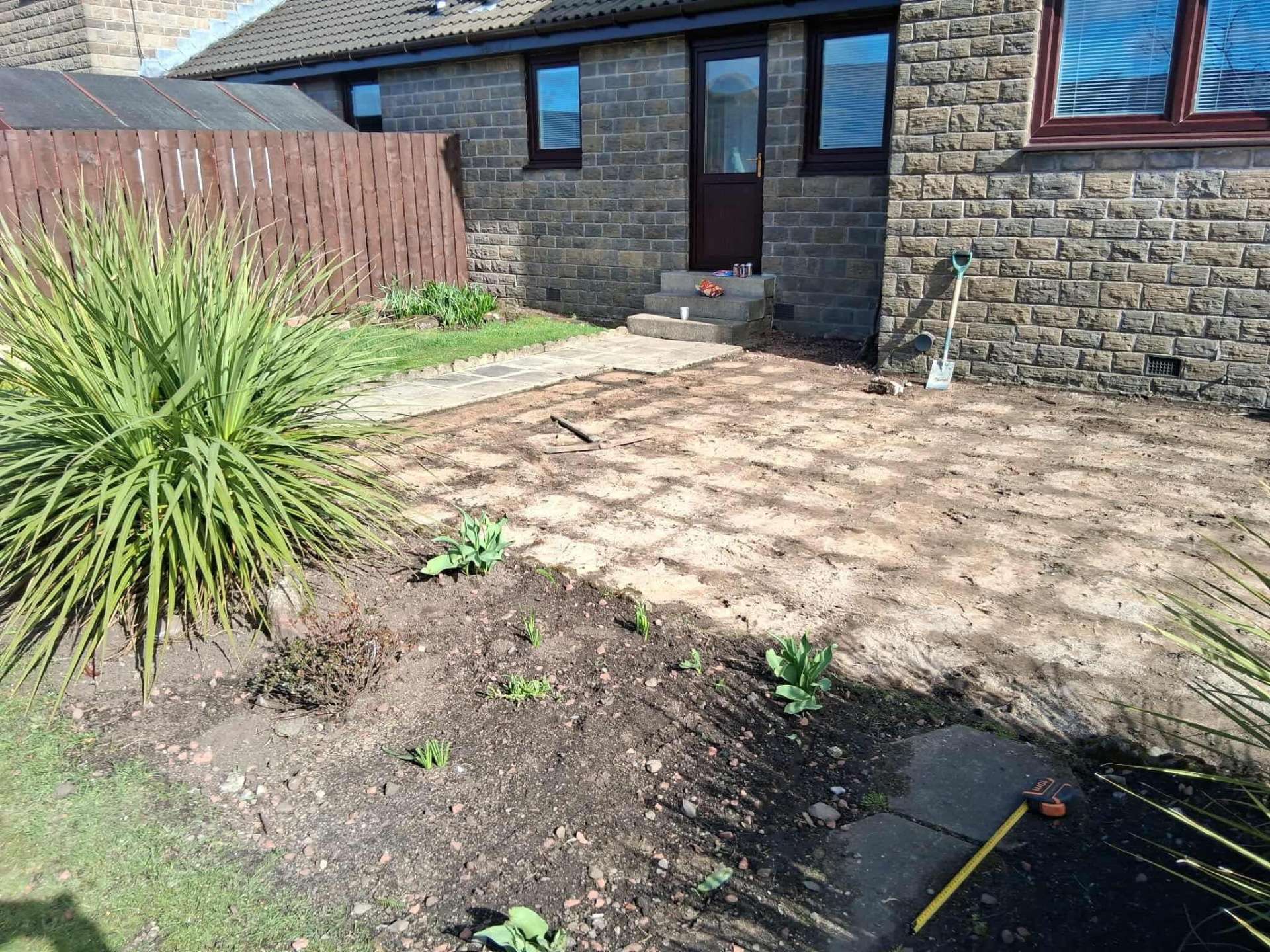 Overgrown front garden before landscaping work