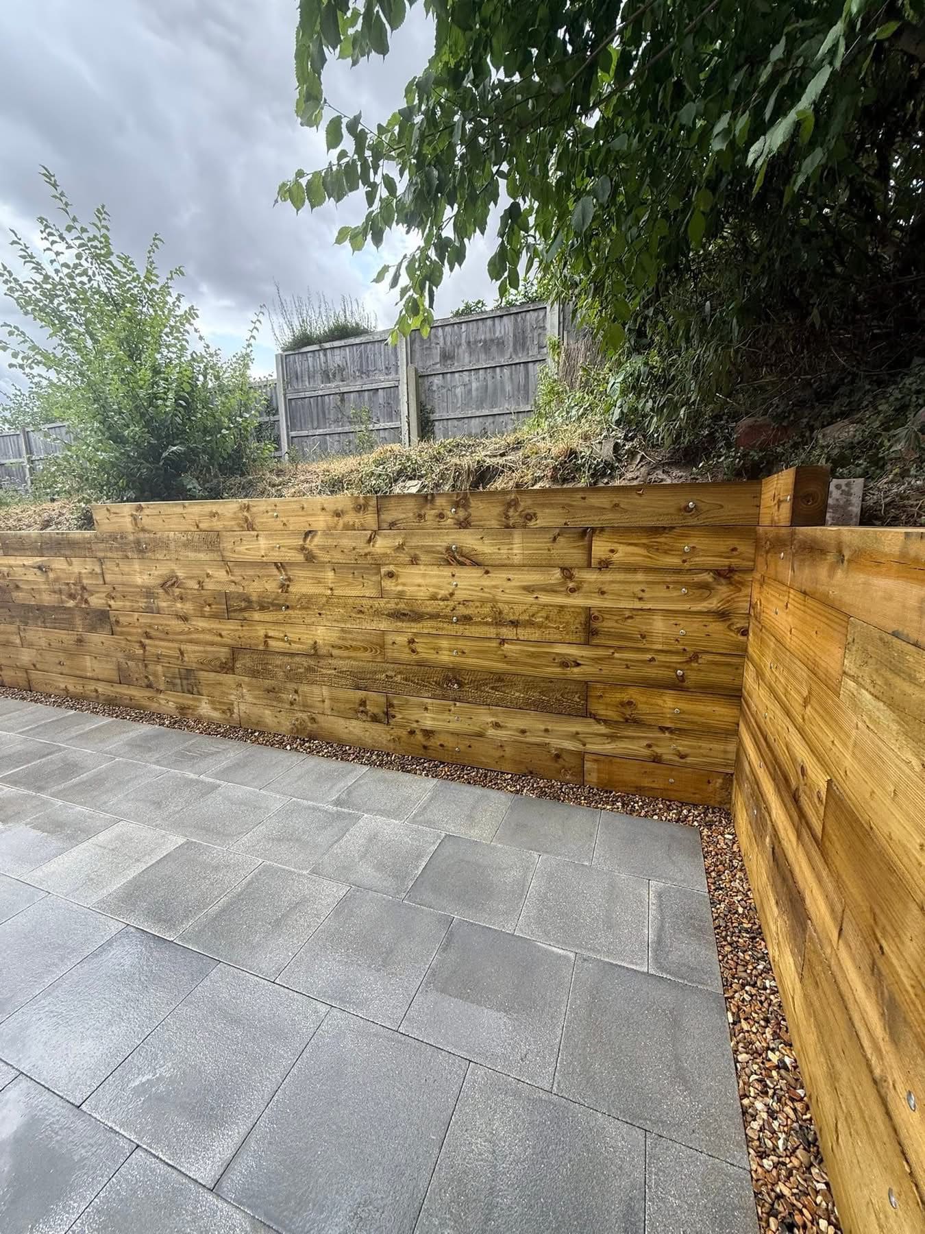 Timber sleeper retaining wall with porcelain patio